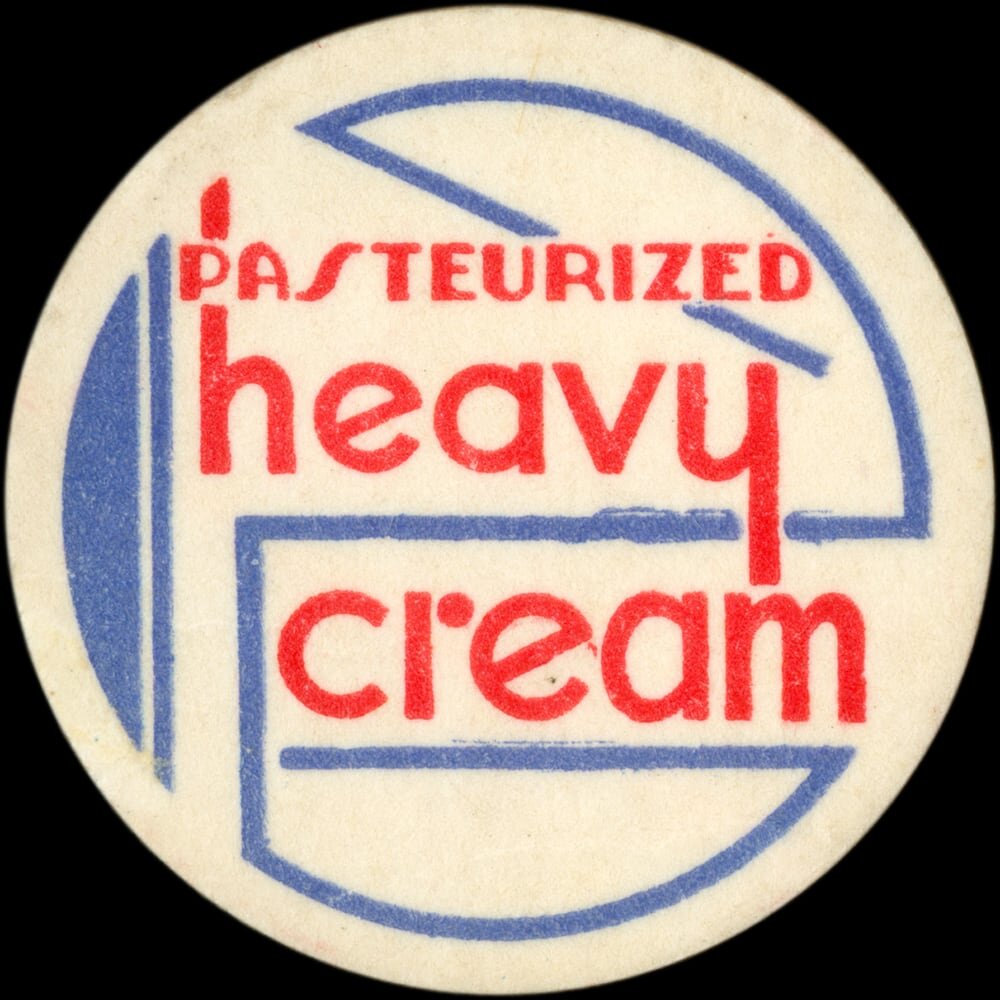 Vintage circular dairy cap with printed typographic milk advertising and a metal pull tab.