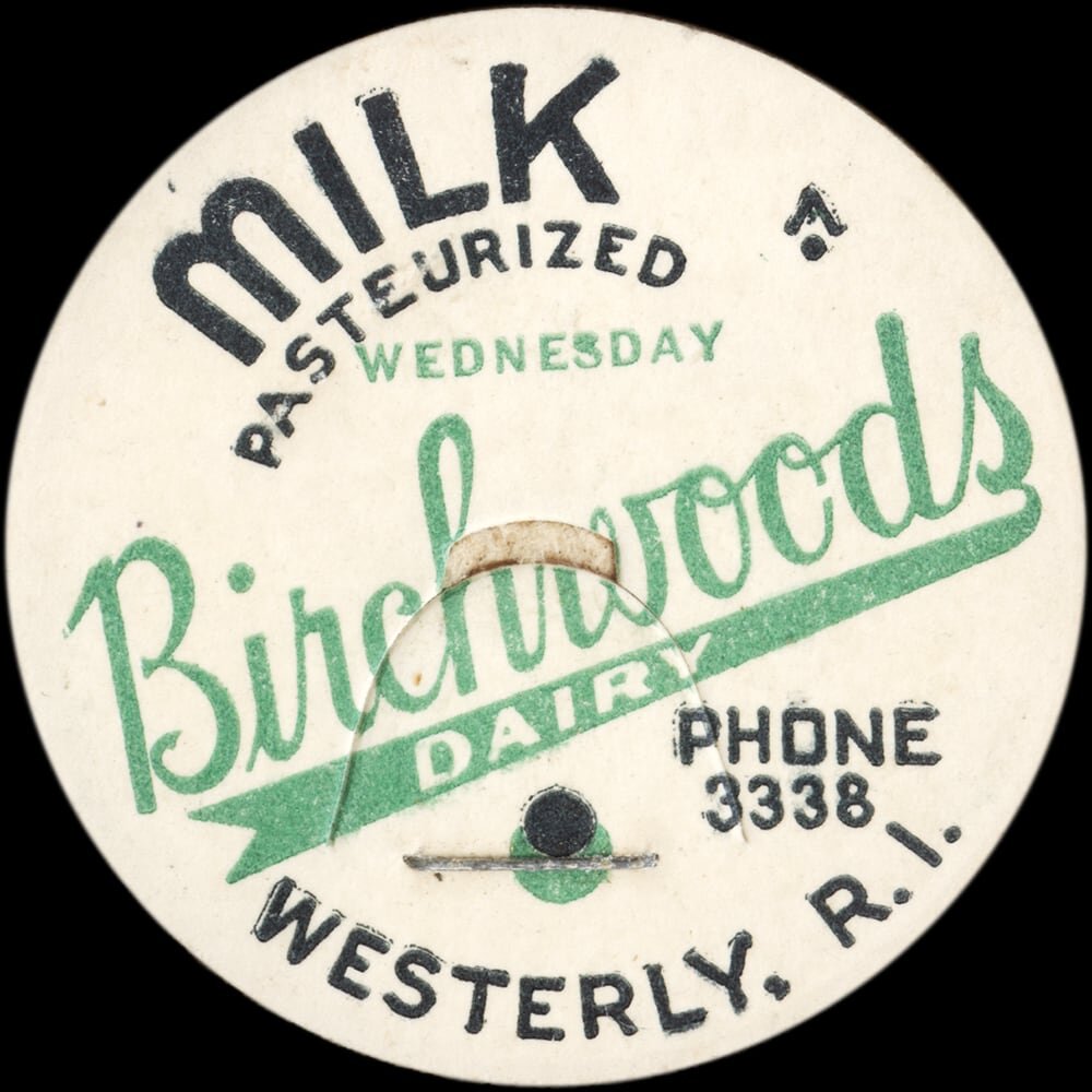 Vintage circular dairy cap with printed typographic milk advertising and a metal pull tab.