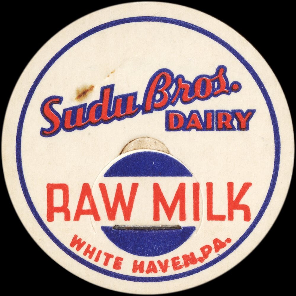 Vintage circular dairy cap with printed typographic milk advertising and a metal pull tab.