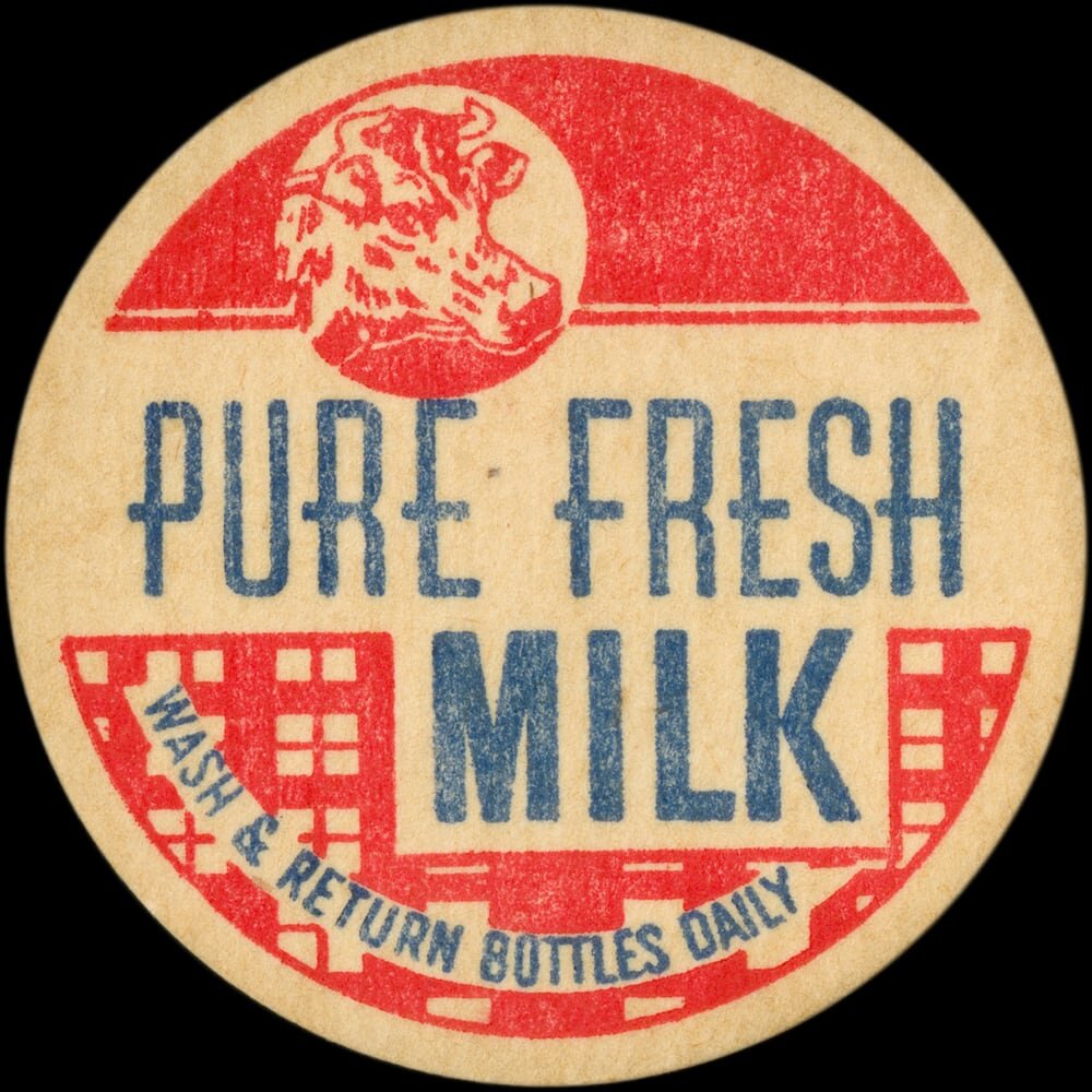 Vintage circular dairy cap with printed typographic milk advertising and a metal pull tab.