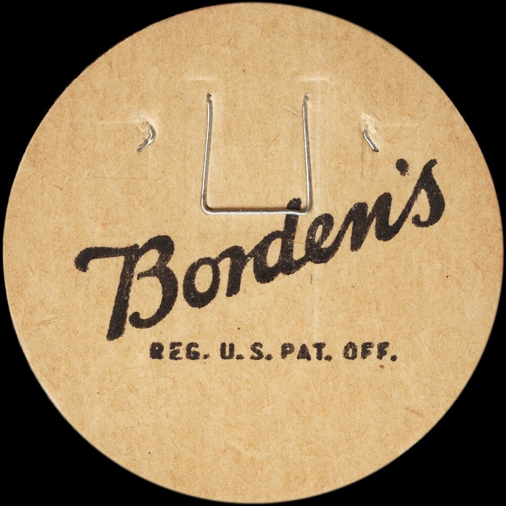 Vintage circular dairy cap with printed typographic milk advertising and a metal pull tab.