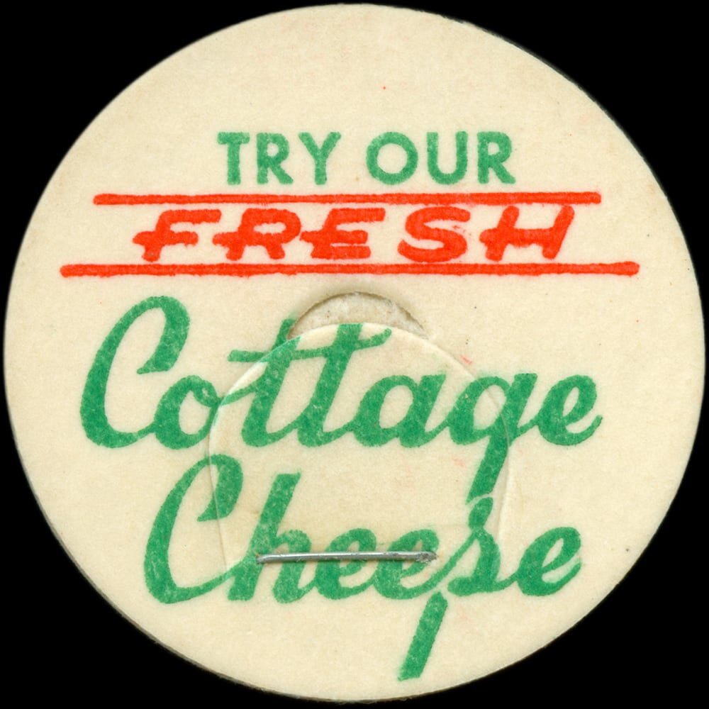 Vintage circular dairy cap with printed typographic milk advertising and a metal pull tab.