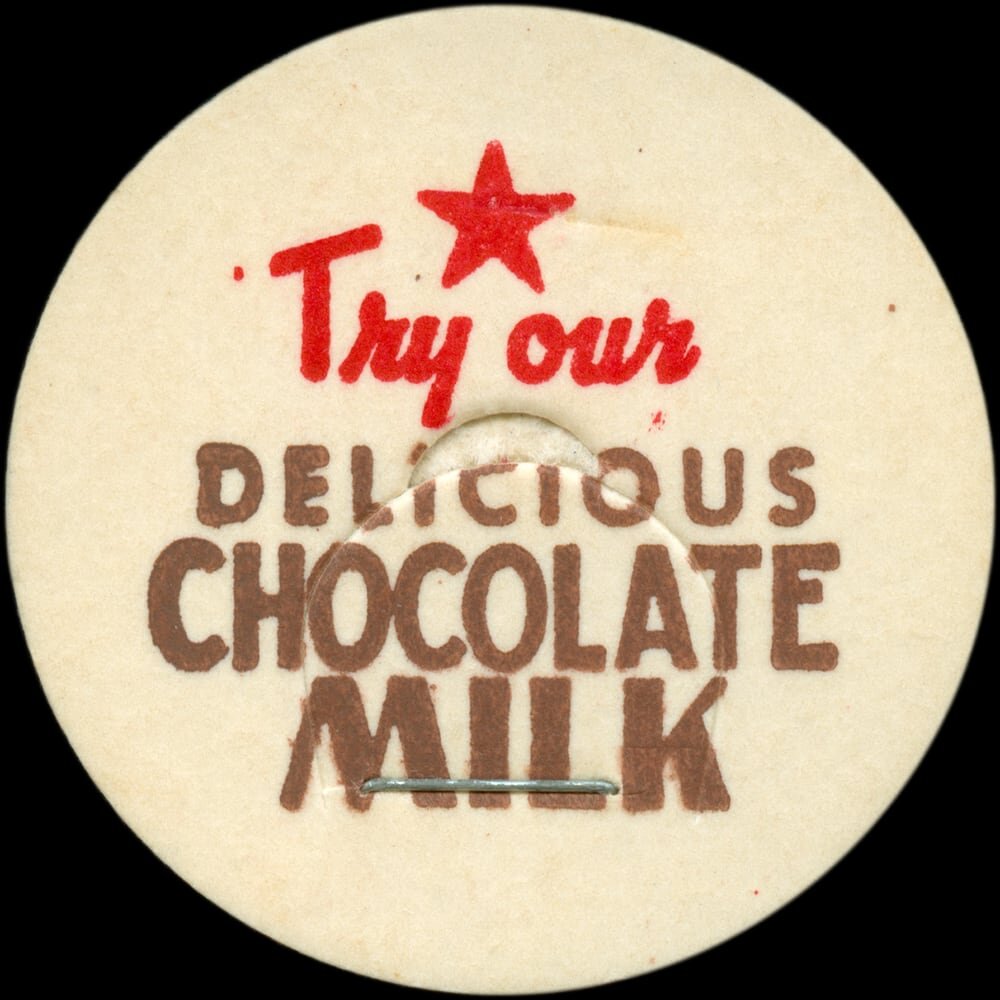 Vintage circular dairy cap with printed typographic milk advertising and a metal pull tab.
