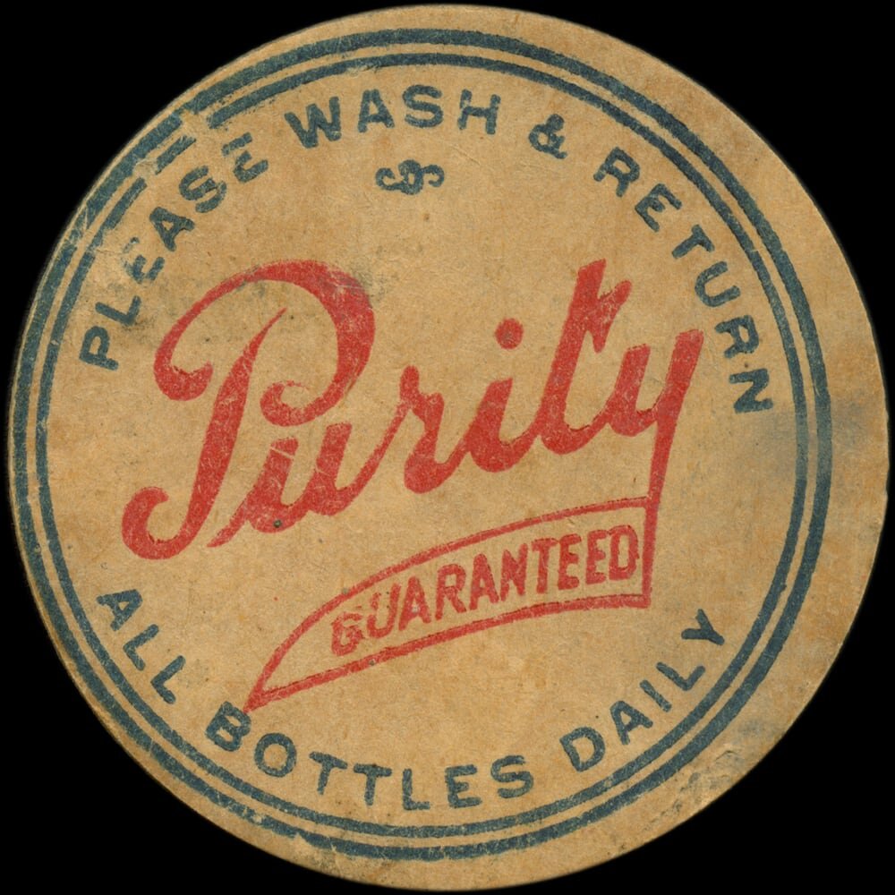 Vintage circular dairy cap with printed typographic milk advertising and a metal pull tab.