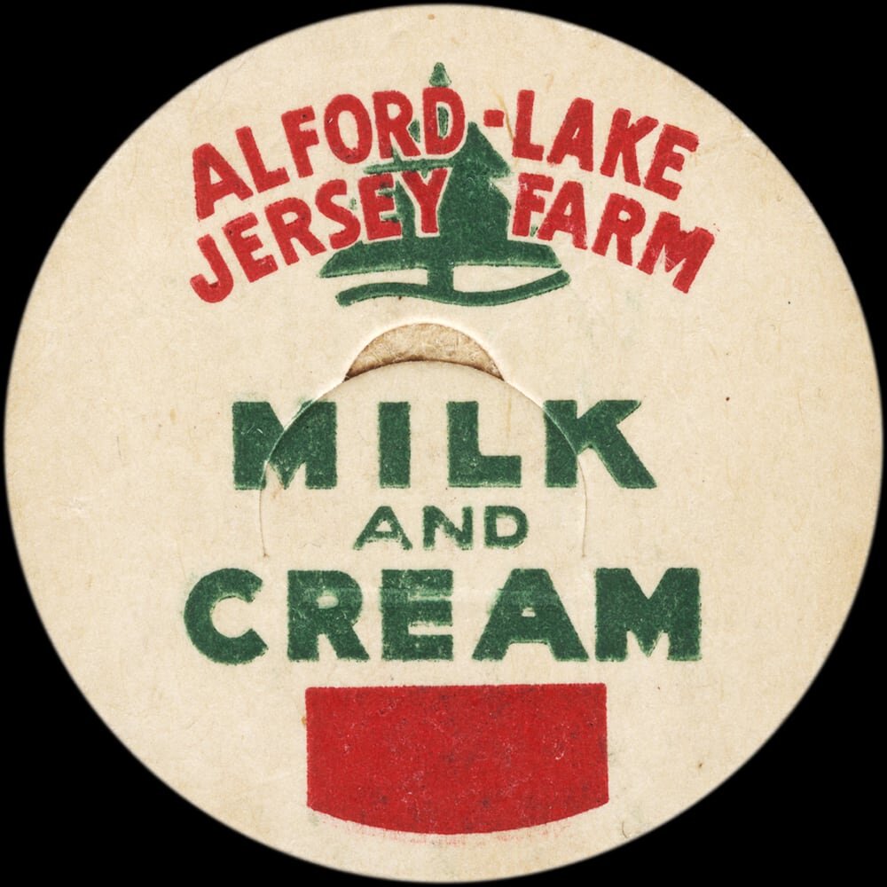 Vintage circular dairy cap with printed typographic milk advertising and a metal pull tab.