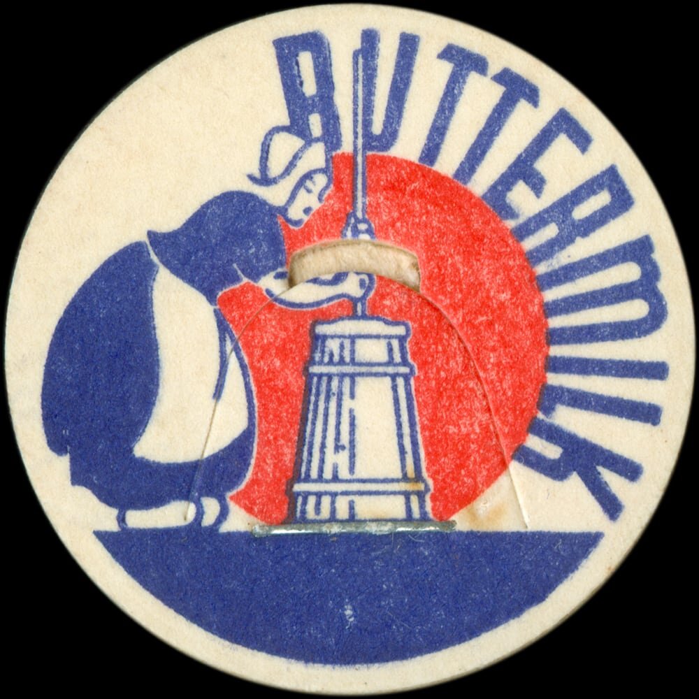 Vintage circular dairy cap with printed typographic milk advertising and a metal pull tab.