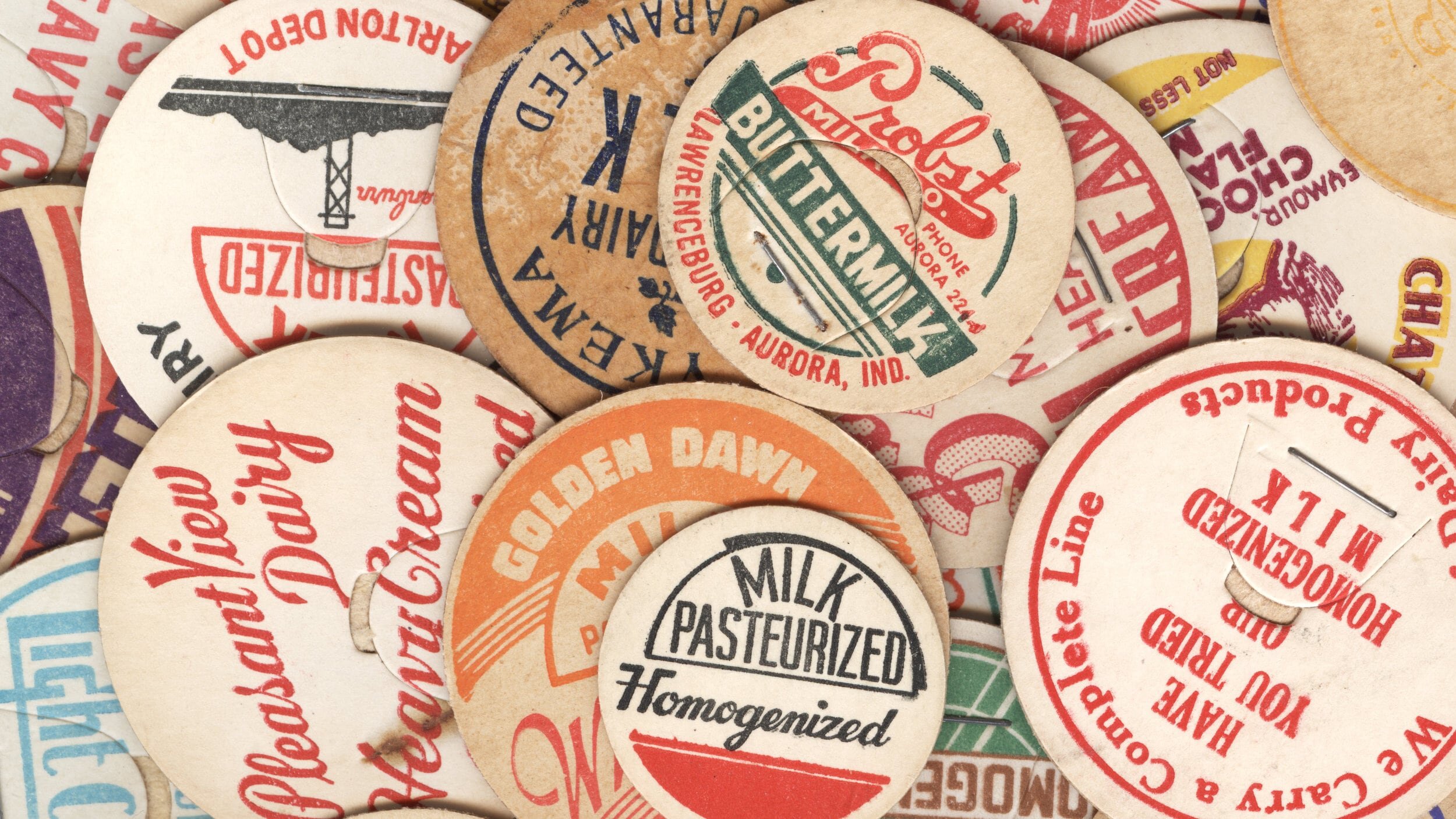 Vintage circular dairy cap with printed typographic milk advertising and a metal pull tab.
