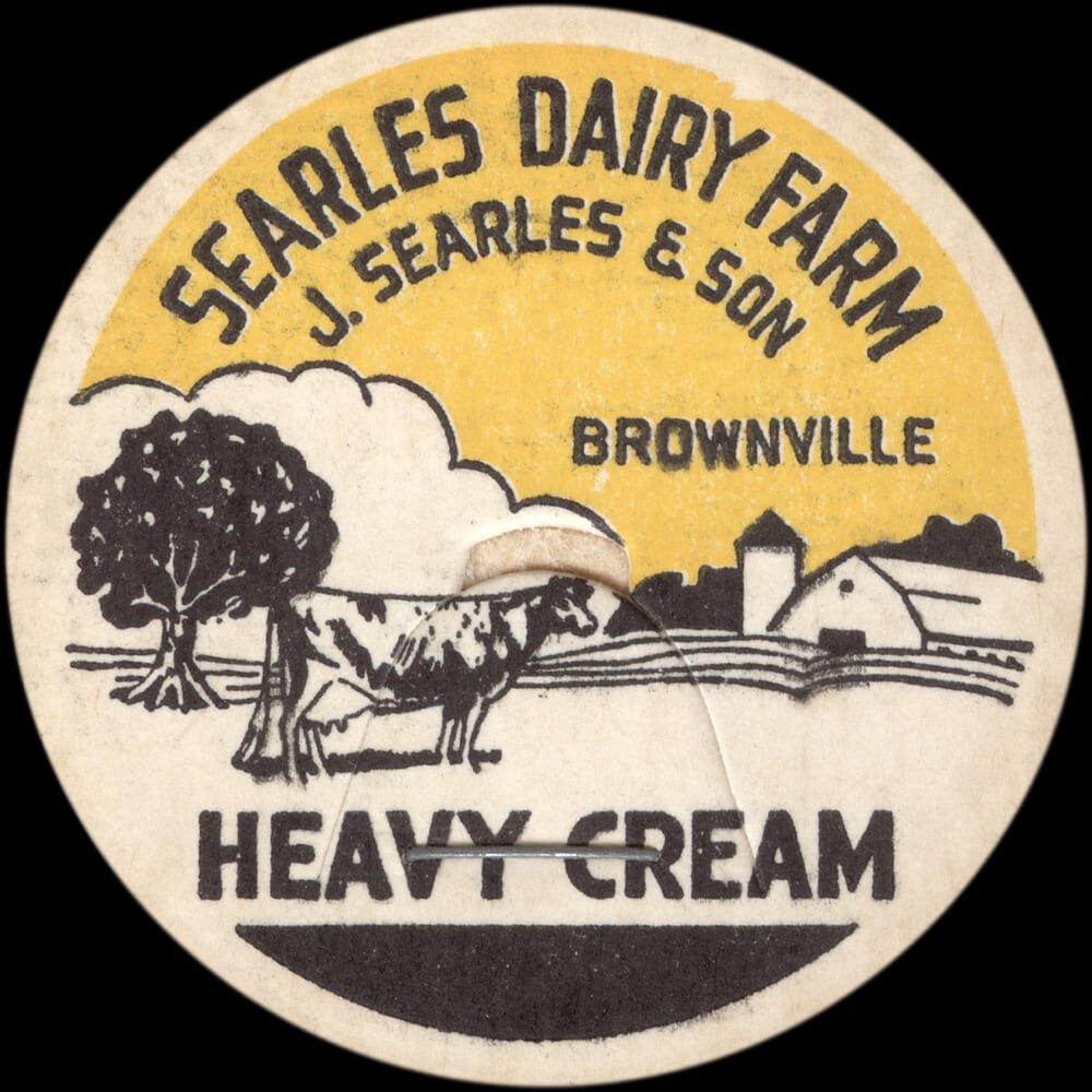 Searles Dairy Farm heavy cream cap with farm and cow illustration.