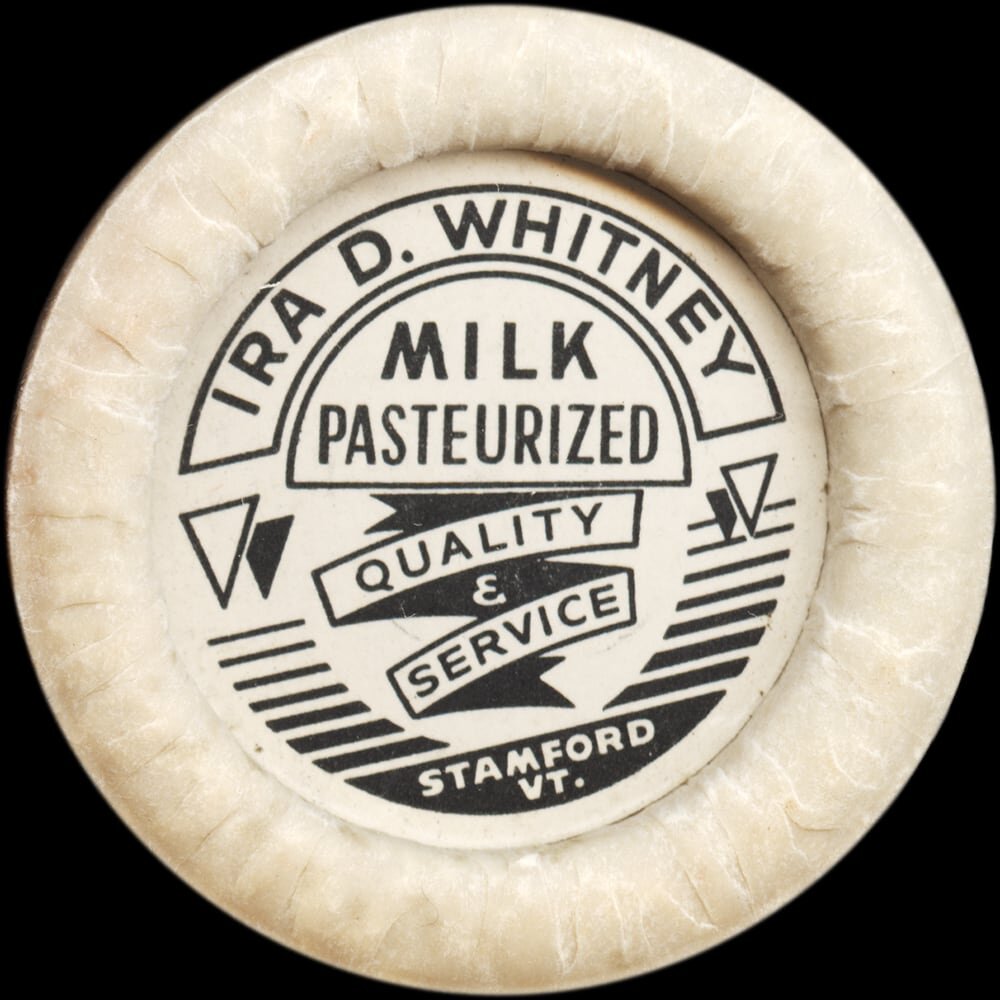 Vintage circular dairy cap with printed typographic milk advertising and a metal pull tab.