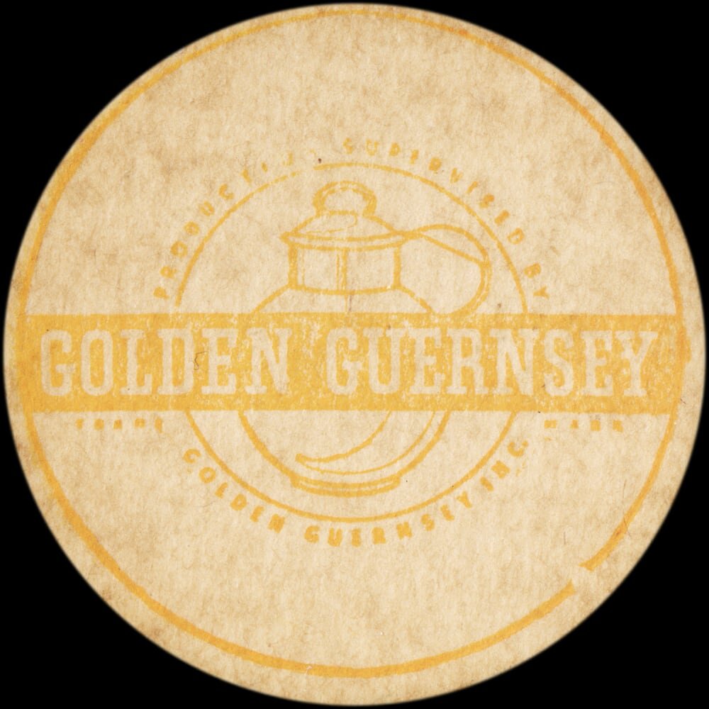 Vintage circular dairy cap with printed typographic milk advertising and a metal pull tab.